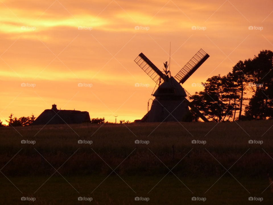Silhouette of house and windmill