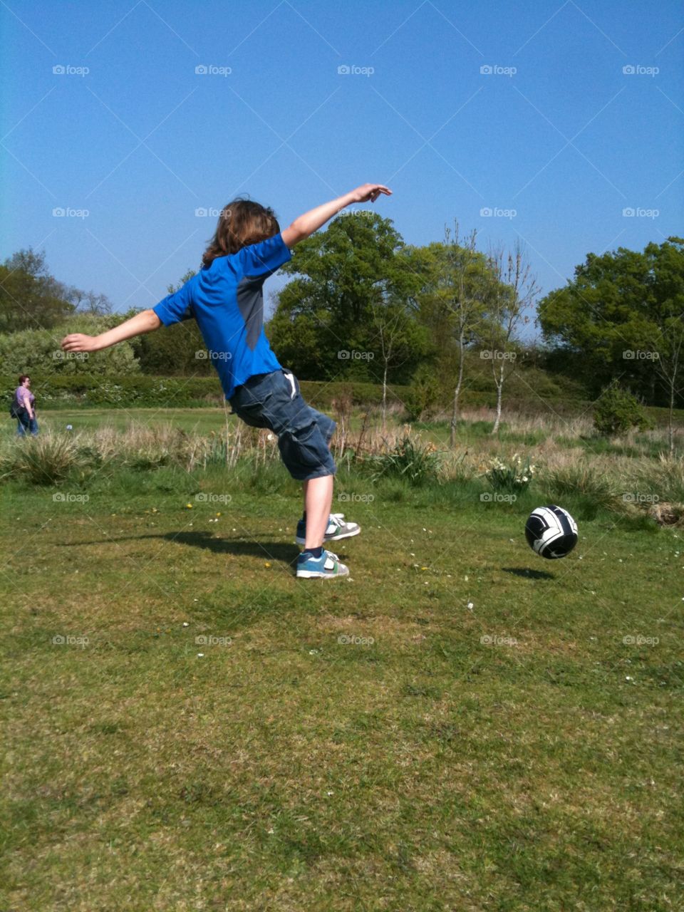 Outdoor summer fun in the sun. Football on the grass. Loving life! Football skills. 