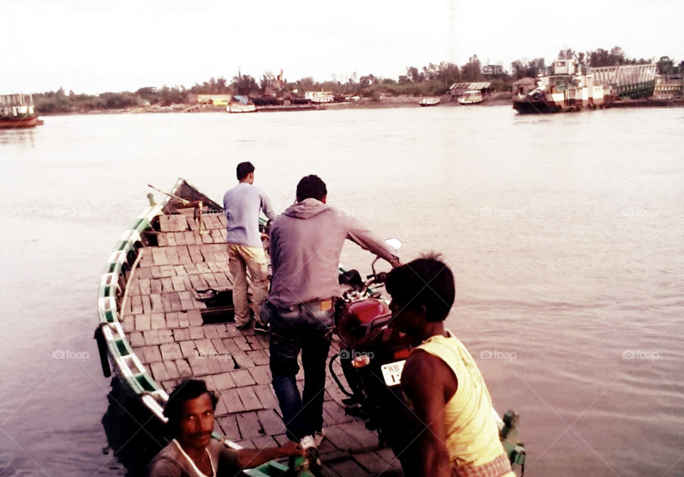 Boats used to carry passengers and light vehicles. Transportation to cross river.