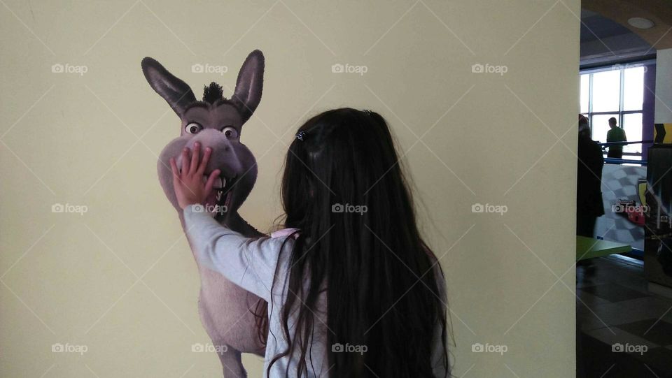 Small girl and a donkey