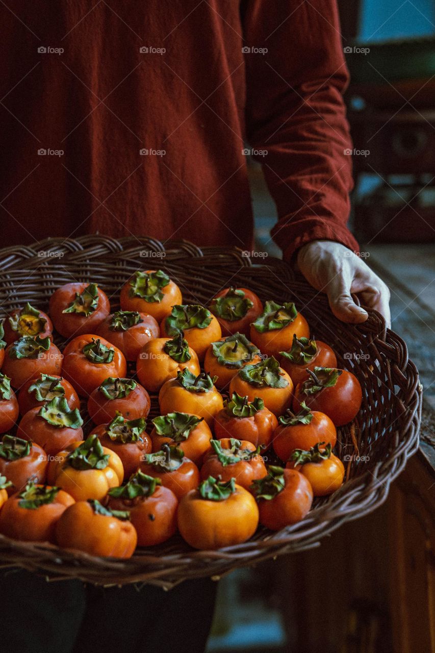 persimmons in wicker Basket