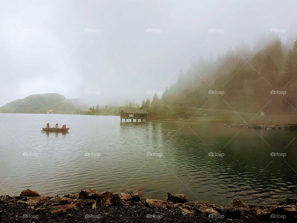 Alpine lake on a foggy morning