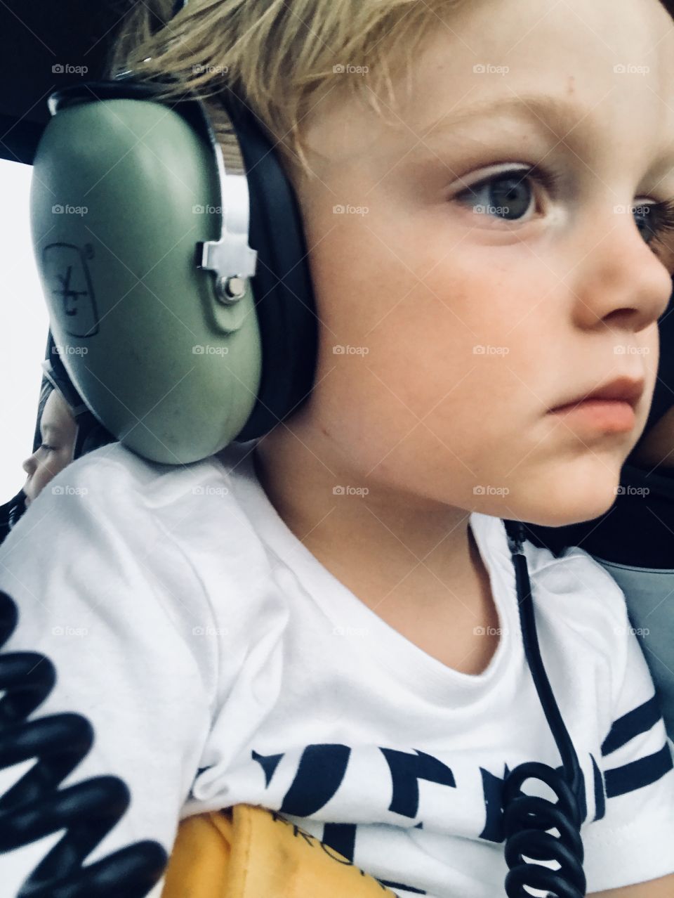 A little excited and a little terrified on his first time in a helicopter. 