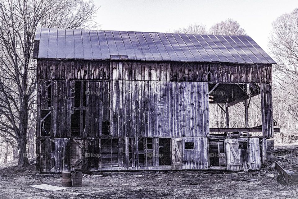 A dilapidated barn shows its age as well as the effects of many decades of weather