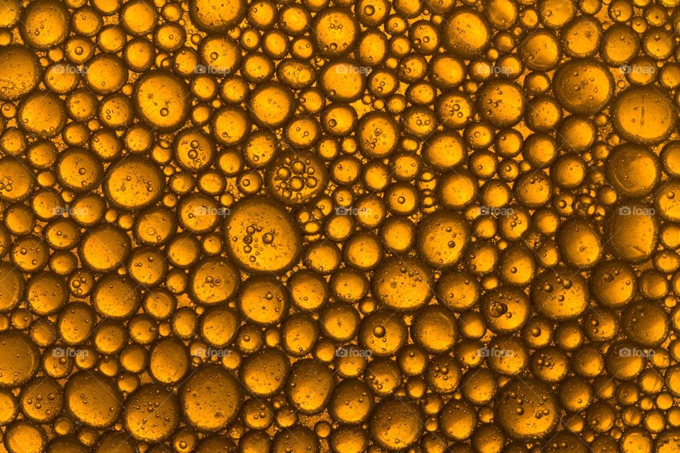Abstract background of an yellow oil bubbles