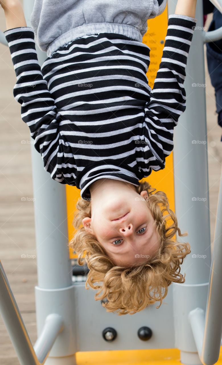 blonde boy hanging with his head down