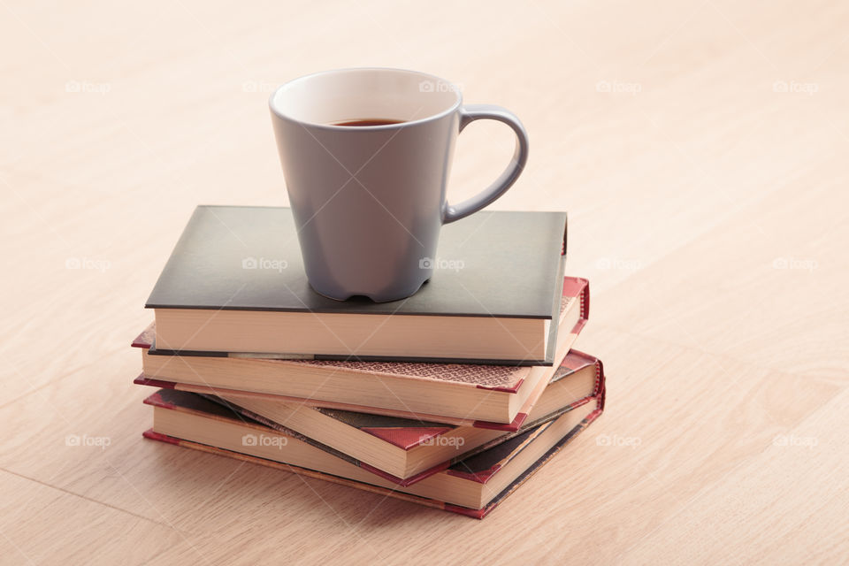 A few books with cup of coffee and cookies on wooden floor. Time for relax. Spending leisure time on reading. Cozy and comfortable. Learning from books 📖Studying for the next exam 😌