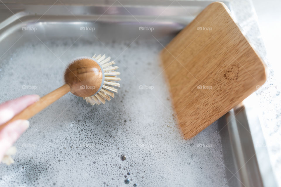 Hand washing with a wooden mop.