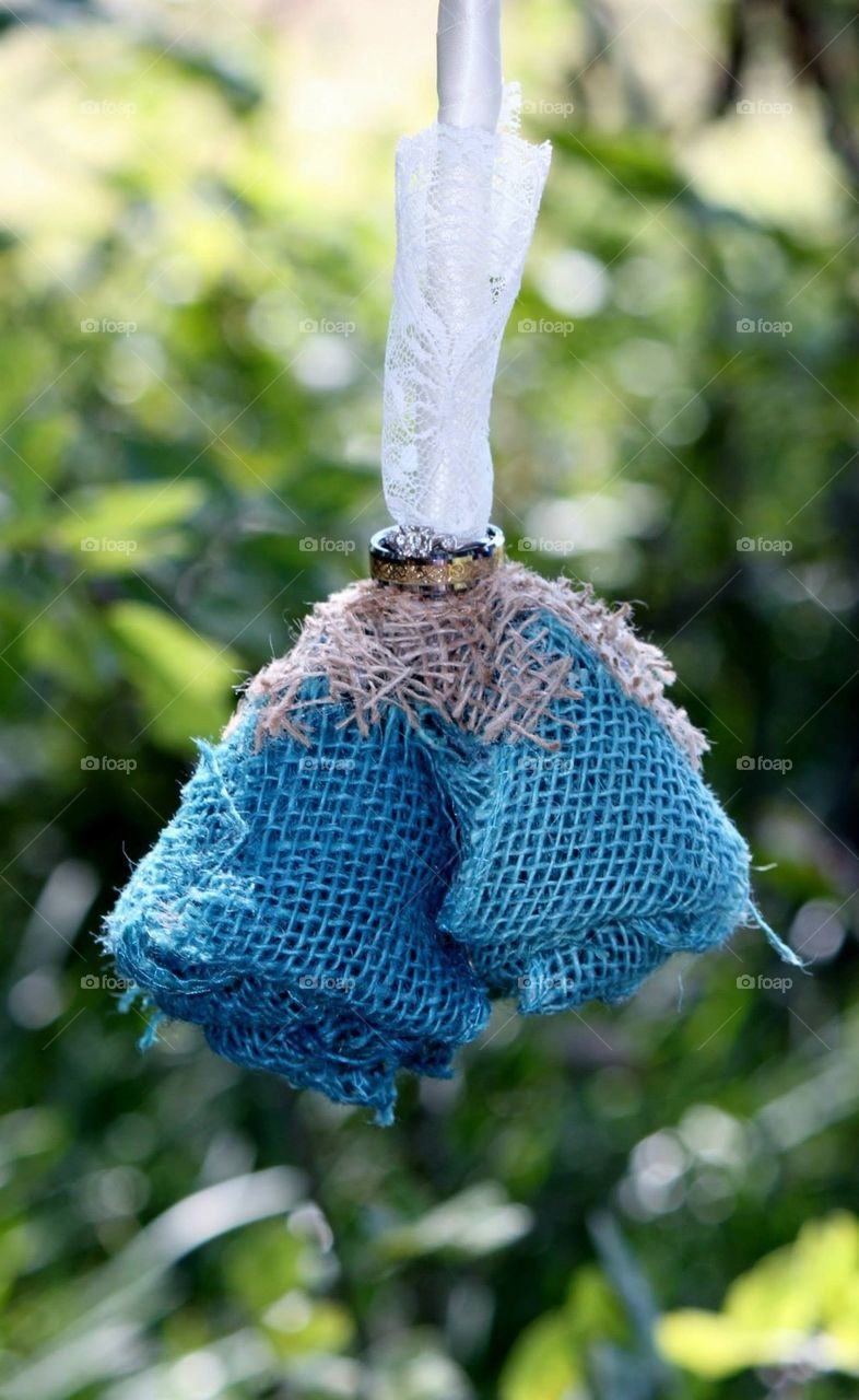 Wedding rings on burlap flower