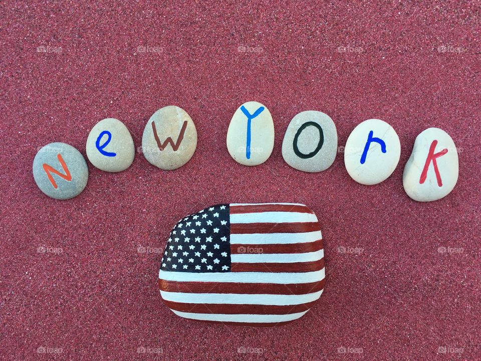 New York, souvenir with stones composition over red sand