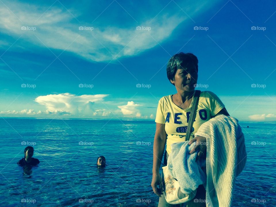 My mom in AERO shirt. Blue Sky in the beautiful beach.