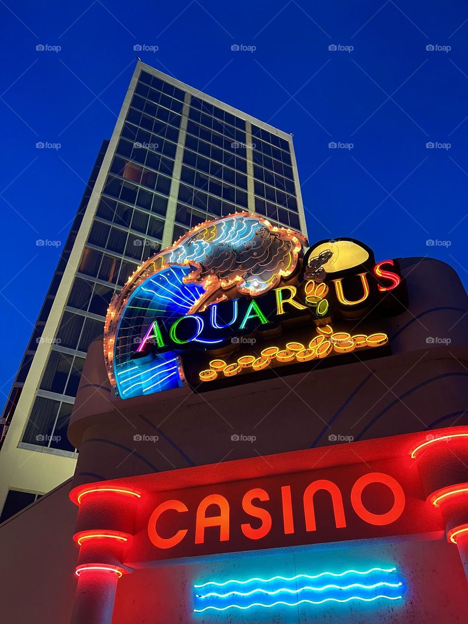 Looking up at the Aquarius casino sign in Laughlin Nevada at night 