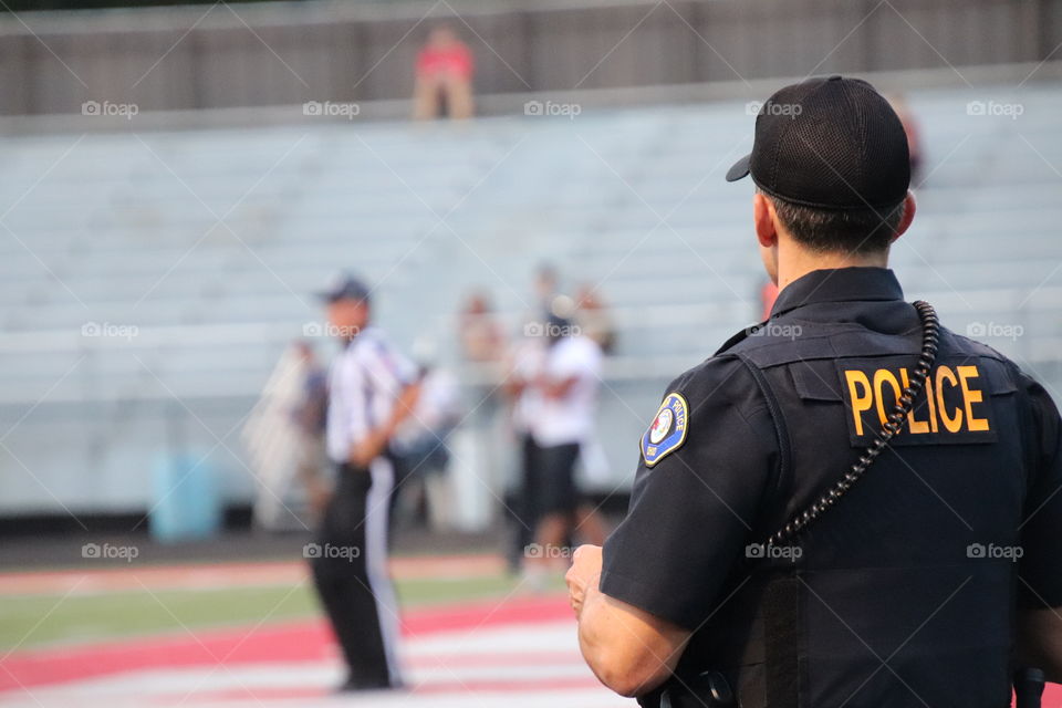 Policeman working at high school football game