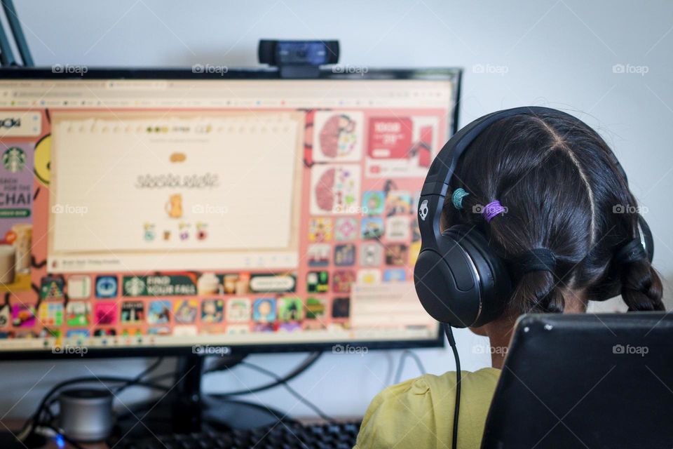 Girl in headphones is playing video games