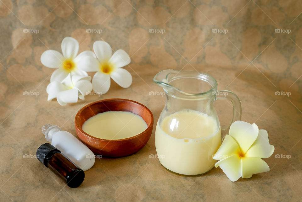Oil, lotion and frangipani on natural background with natural light