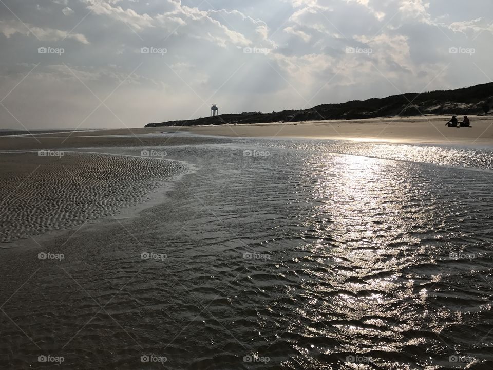 Two human sitting on the beach