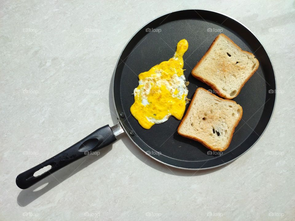 Egg omelette with bread toast in a pan, home made simple breakfast, healthy egg recipes, egg dishes