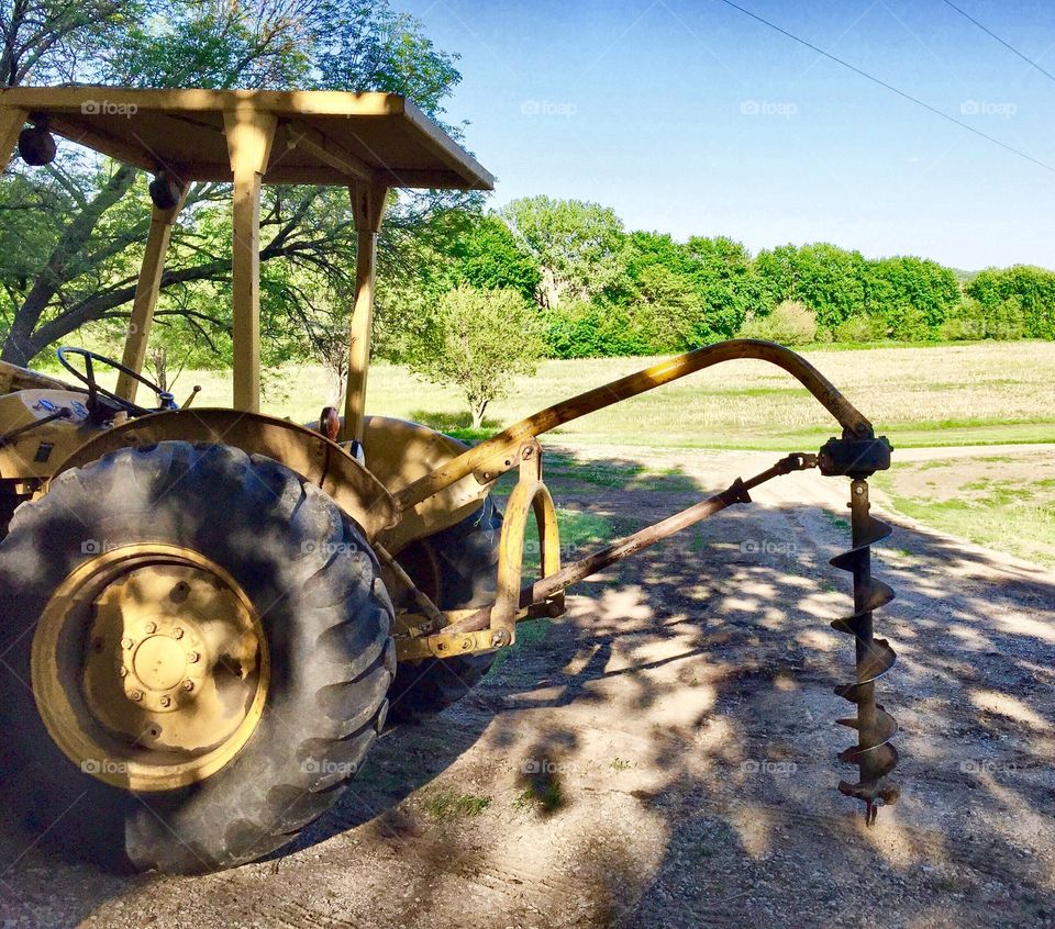 Tractor with a post hole-digger