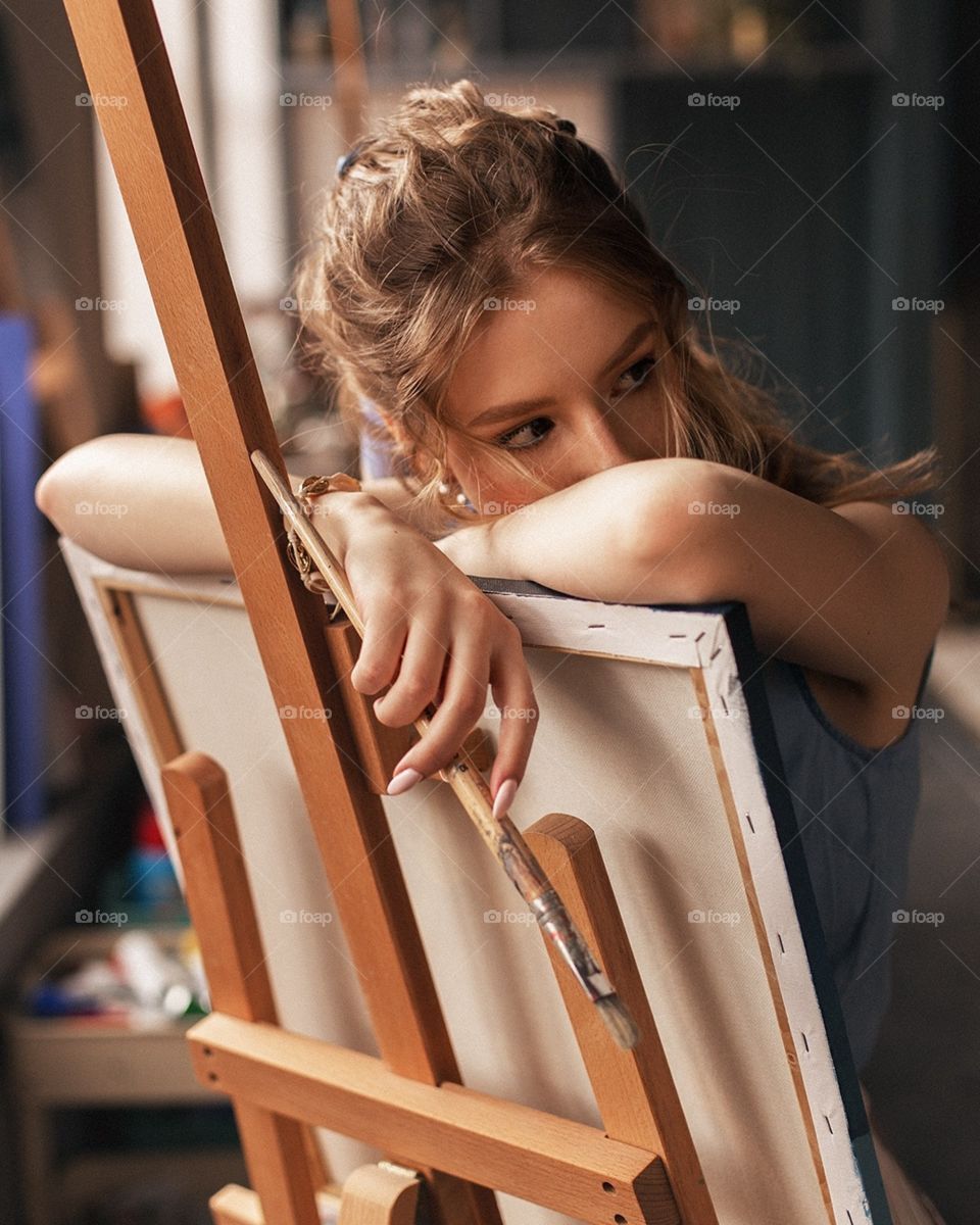 trying to create some art while it is in front of us ,beautiful girl painting