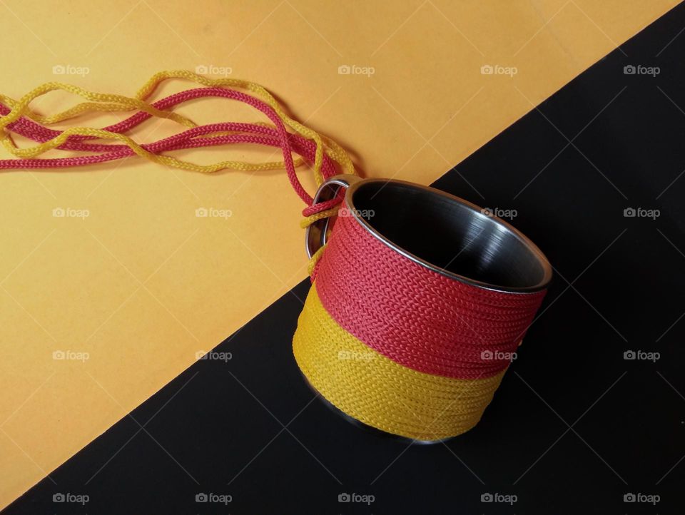 a metal cup with ropes