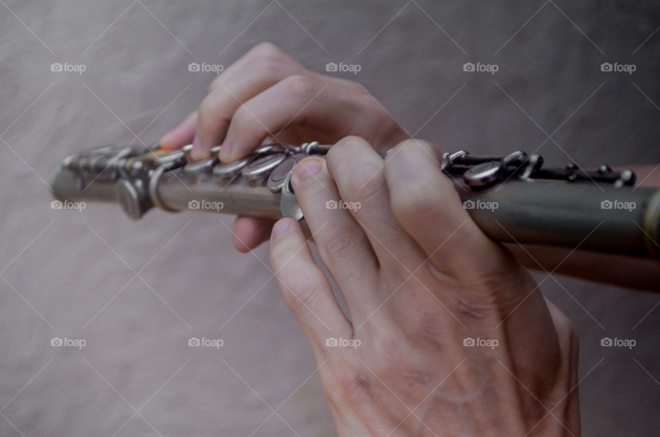 young man playing transverse flute.