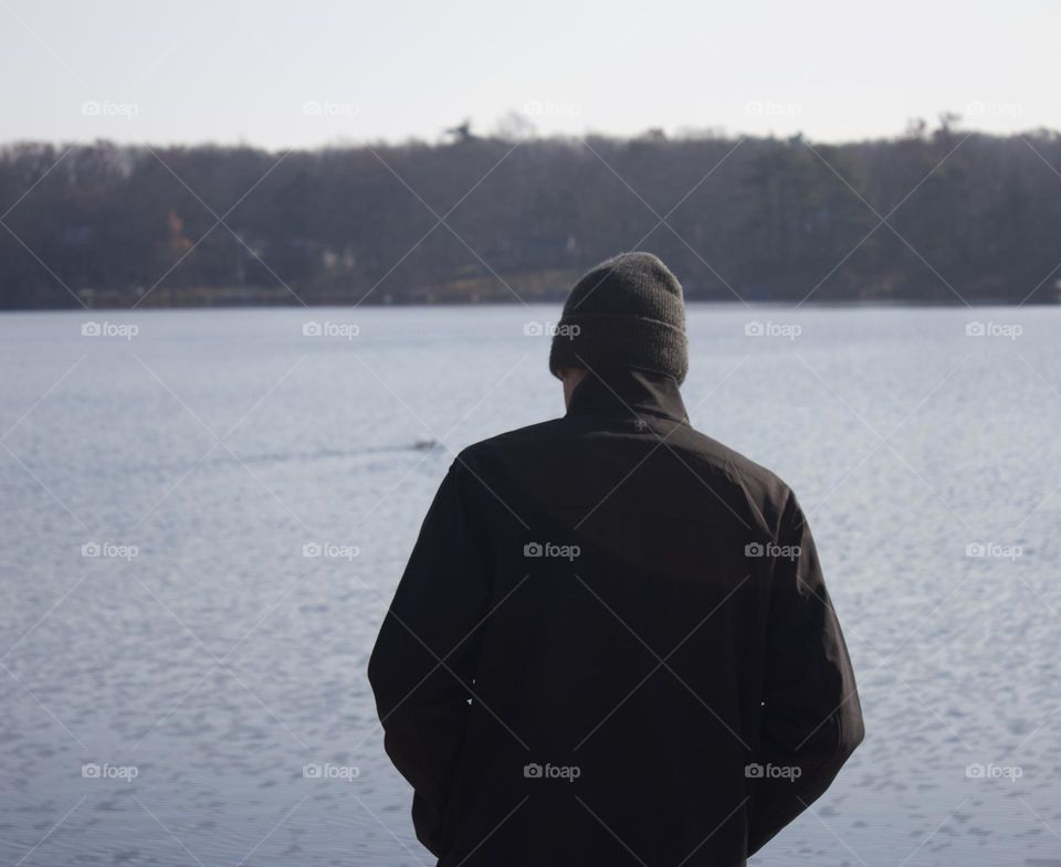 Man standing in front of a Lake