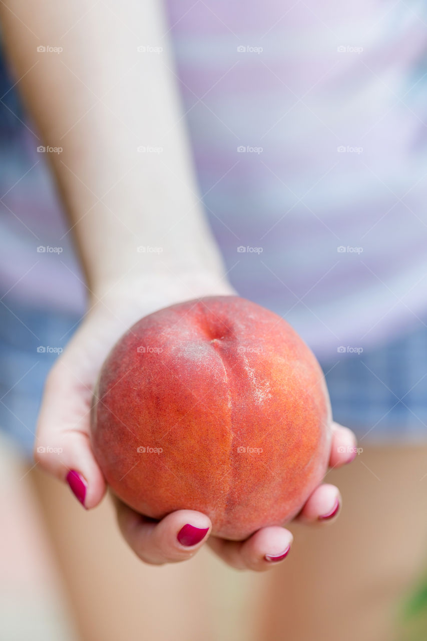 Juicy peach in hand