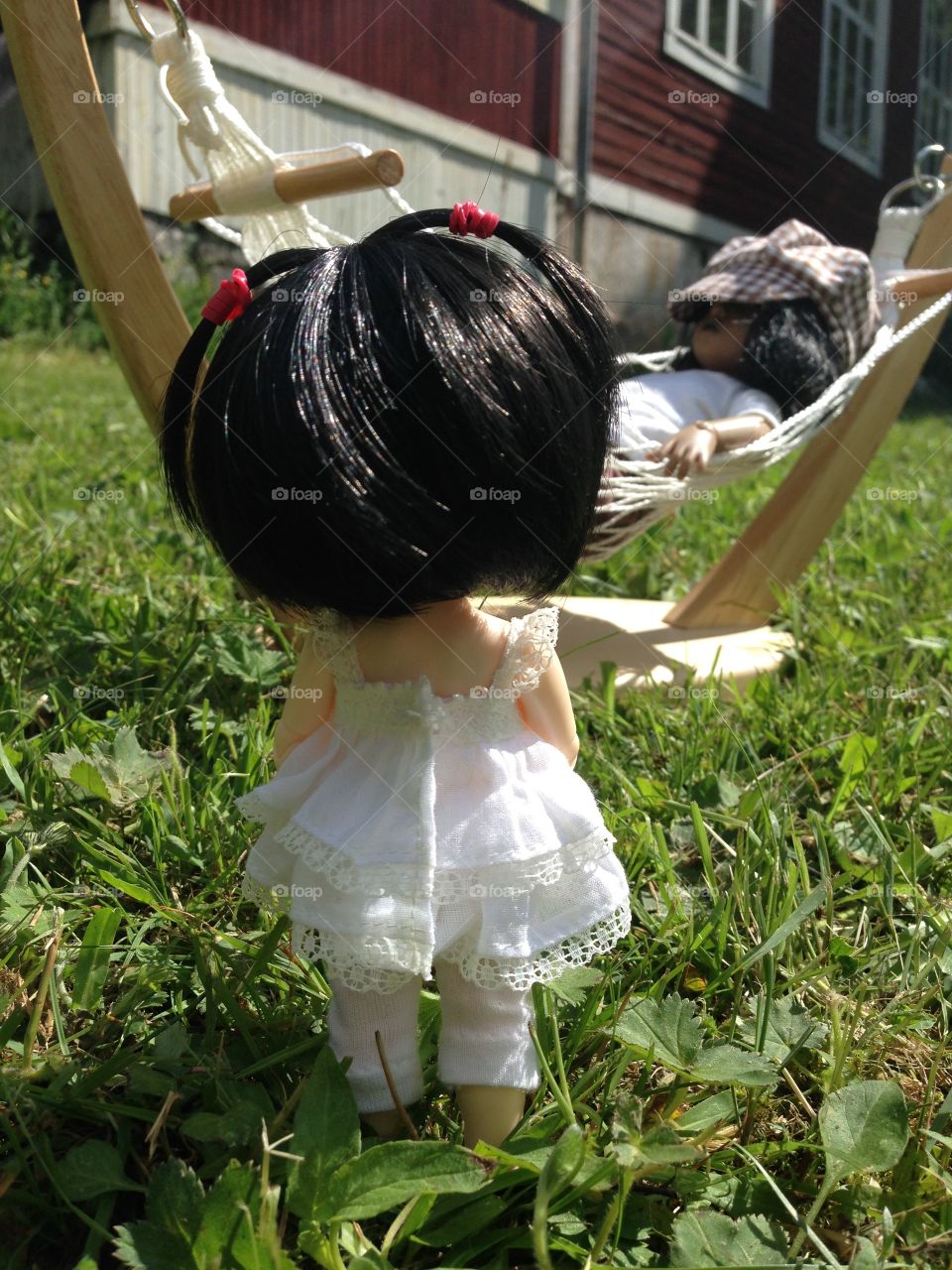 Small doll approaching her friend.