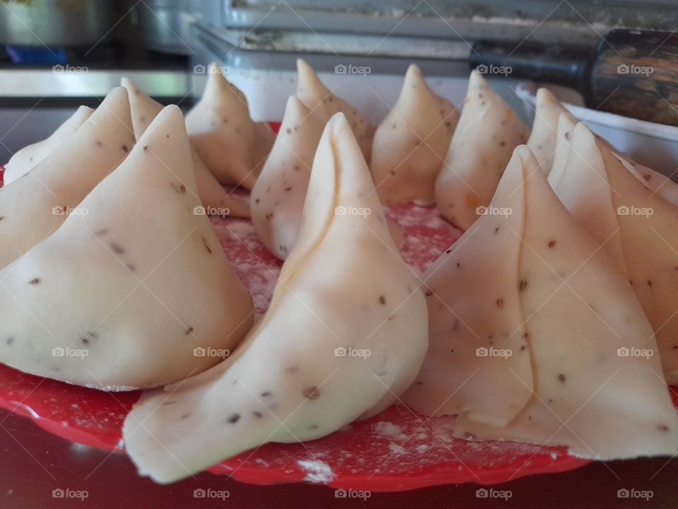 A samosa or singara is a fried or baked pastry with a savory filling, including ingredients such as spiced potatoes, onions, and peas