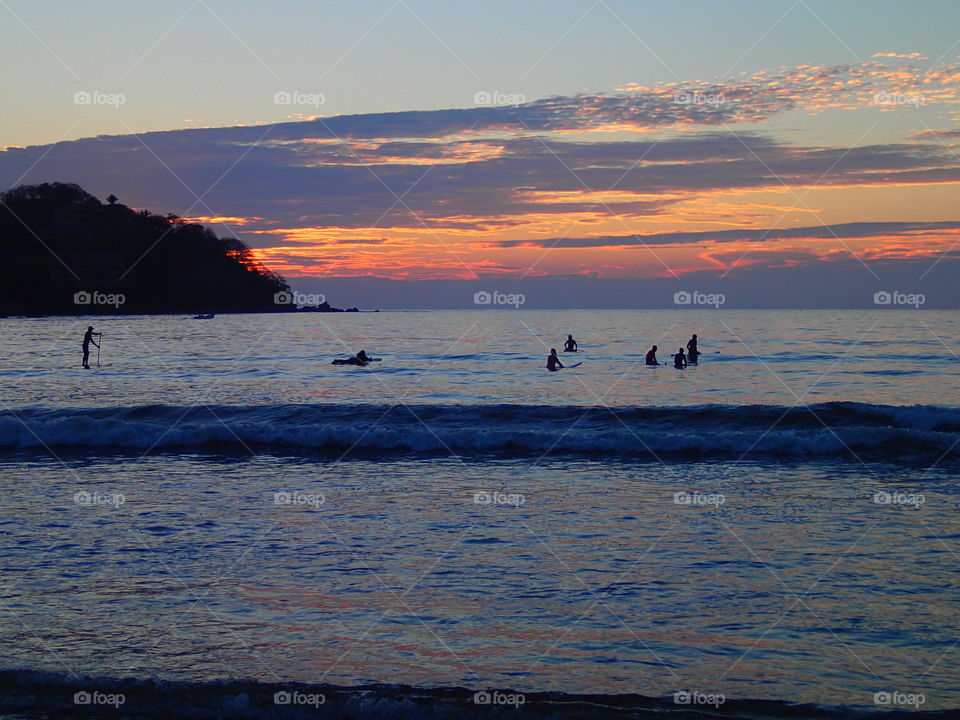 Surfers at sunset