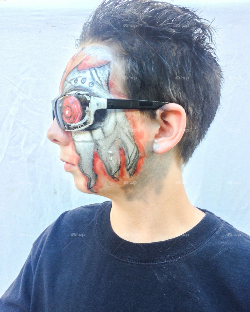 Side view of boy with painted face