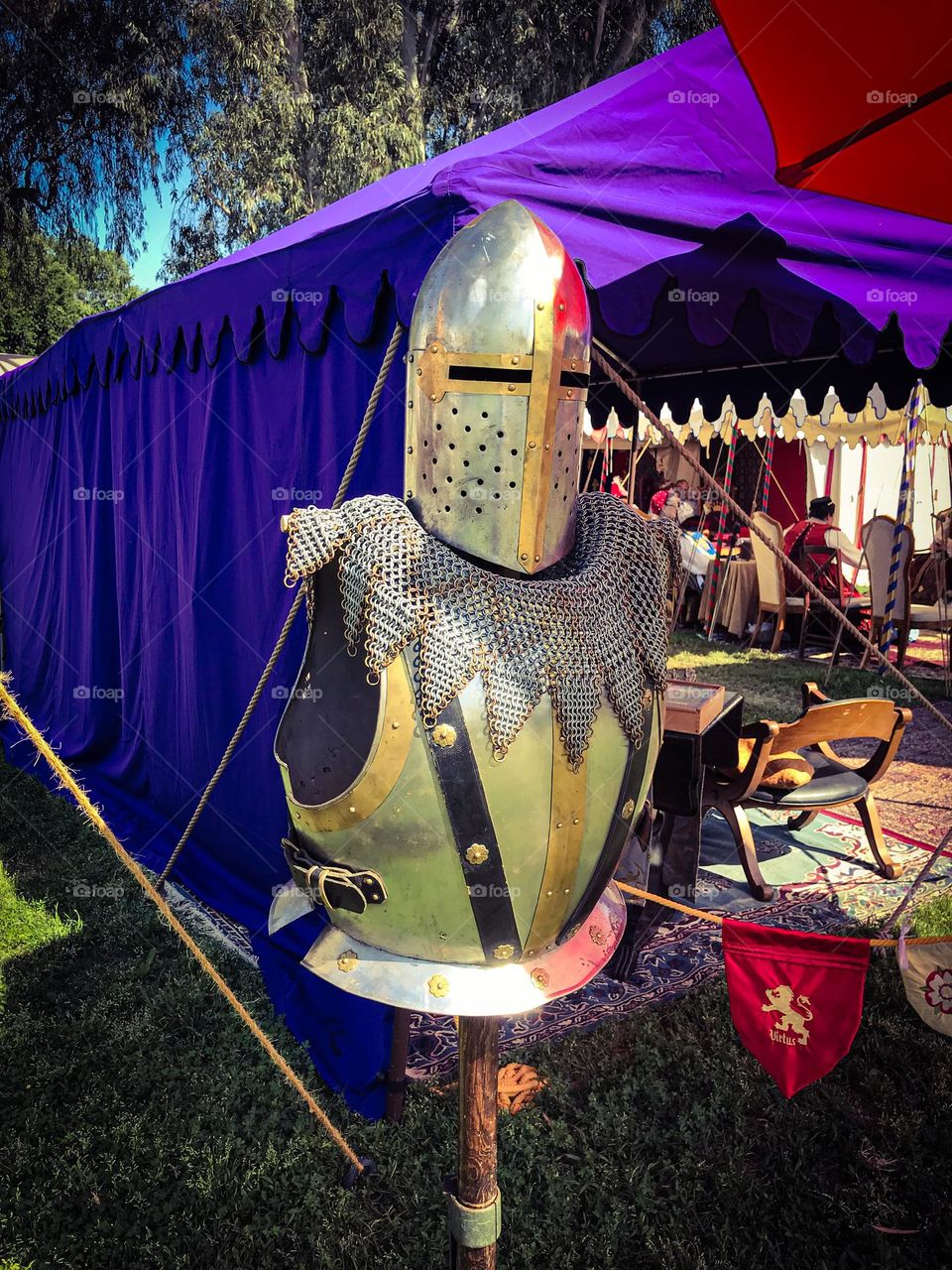 A knight cuirass and helm of the medieval period on public display during the Renaissance Faire in Visalia, California. The entire masterpiece is an unforgettable icon of military history to admire and appreciate.
