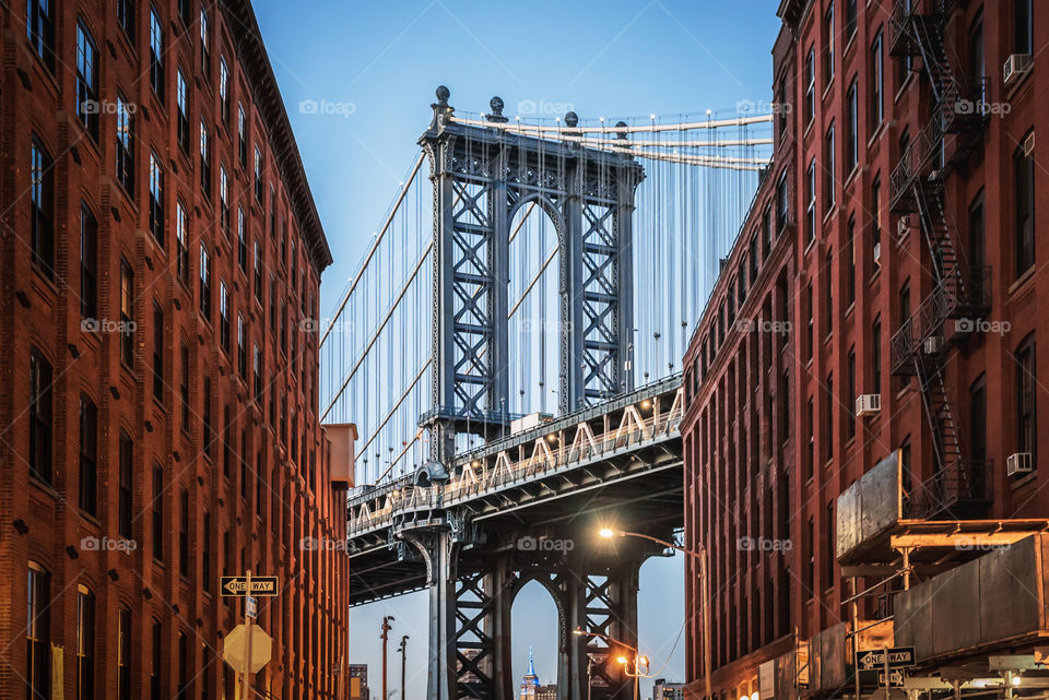 Dumbo - The Manhattan bridge between two red brick buildings in Brooklyn 