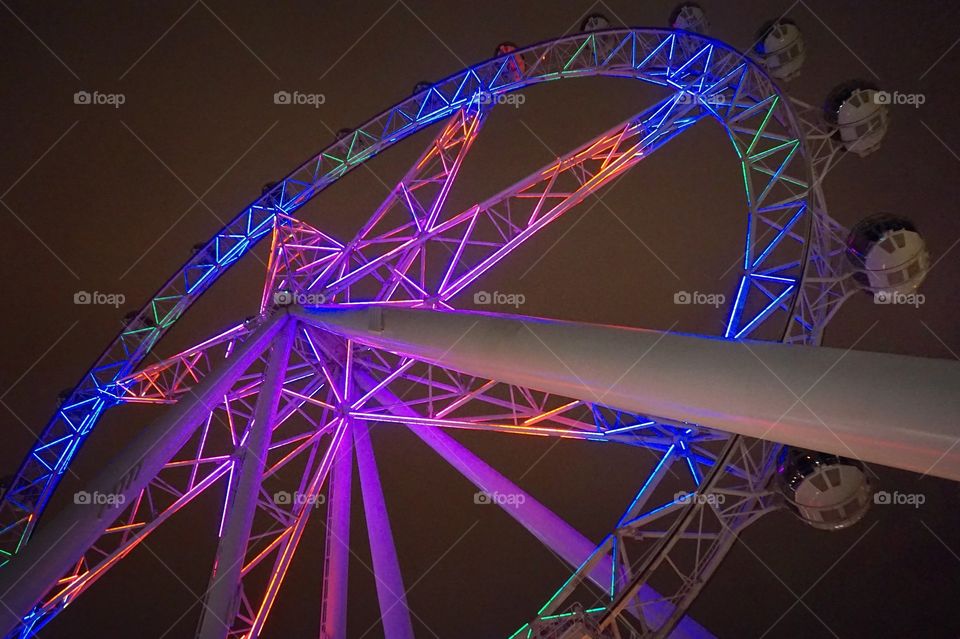 The Melbourne Star, a giant observation/ferris wheel, lit up at night in Melbourne, AU