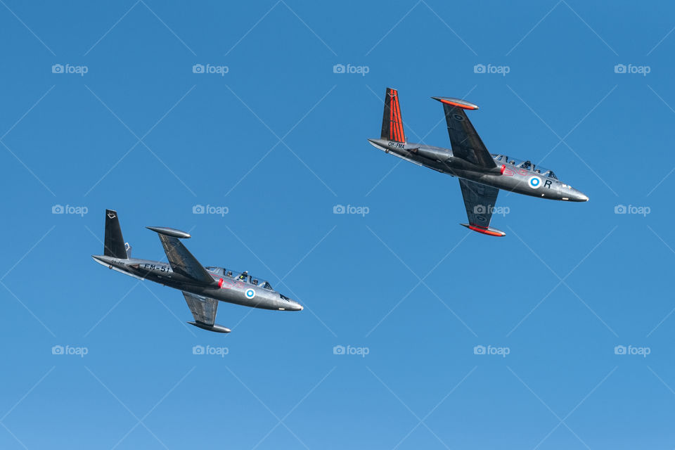 Helsinki, Finland - 9 June 2017: Two Silver Jets Aerobatic Team Fouga CM 170 Magister jets flying at the Kaivopuisto Air Show in Helsinki, Finland.