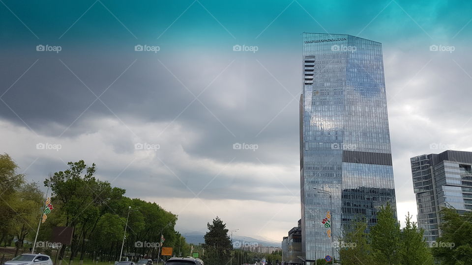 skyscraper in stormy weather with reflections