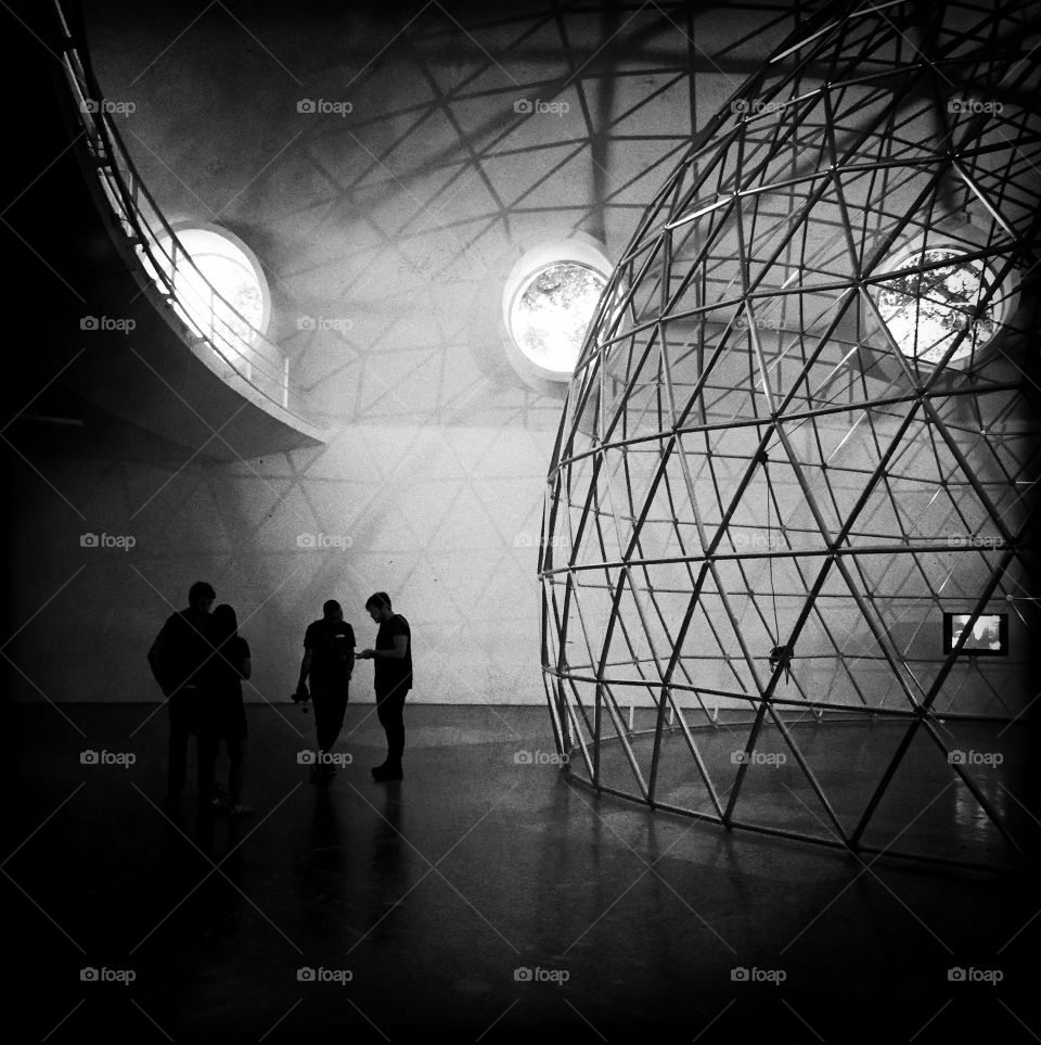 Men beside metal structure