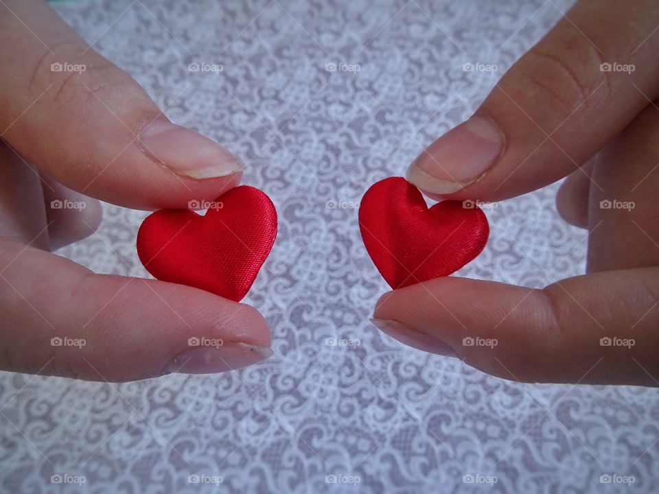 Holding red hearts