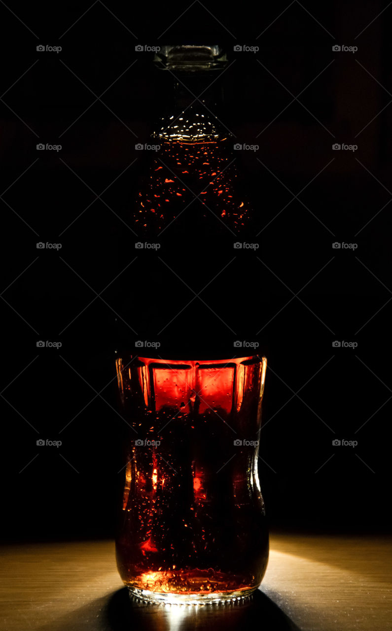 Always Coca-Cola. Bottle of Coca-Cola on a black background.