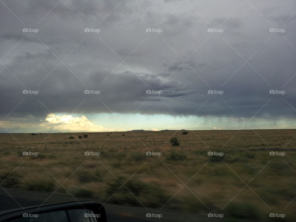 Scenic view of landscape against dramatic sky