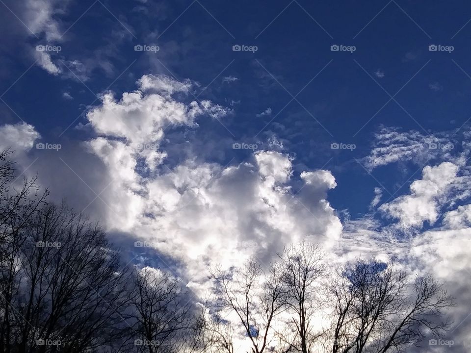 sun lighting up afternoon clouds