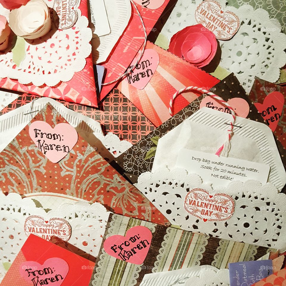 Handmade valentines showing your heartfelt sentiment. Lacey doilies and colorful paper hold homemade bath salt tea bags.