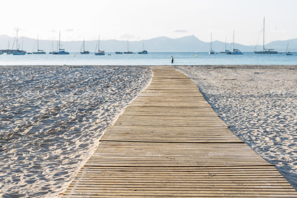Walking on a beautiful boardwalk on the beach in early morning 
