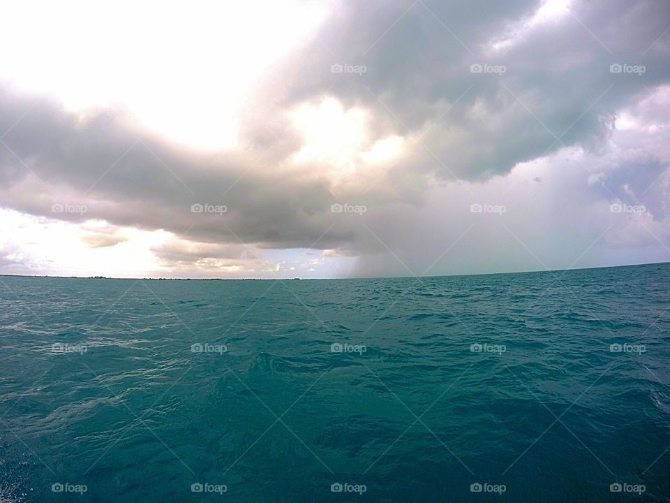 grey stormy cloud over blue ocean