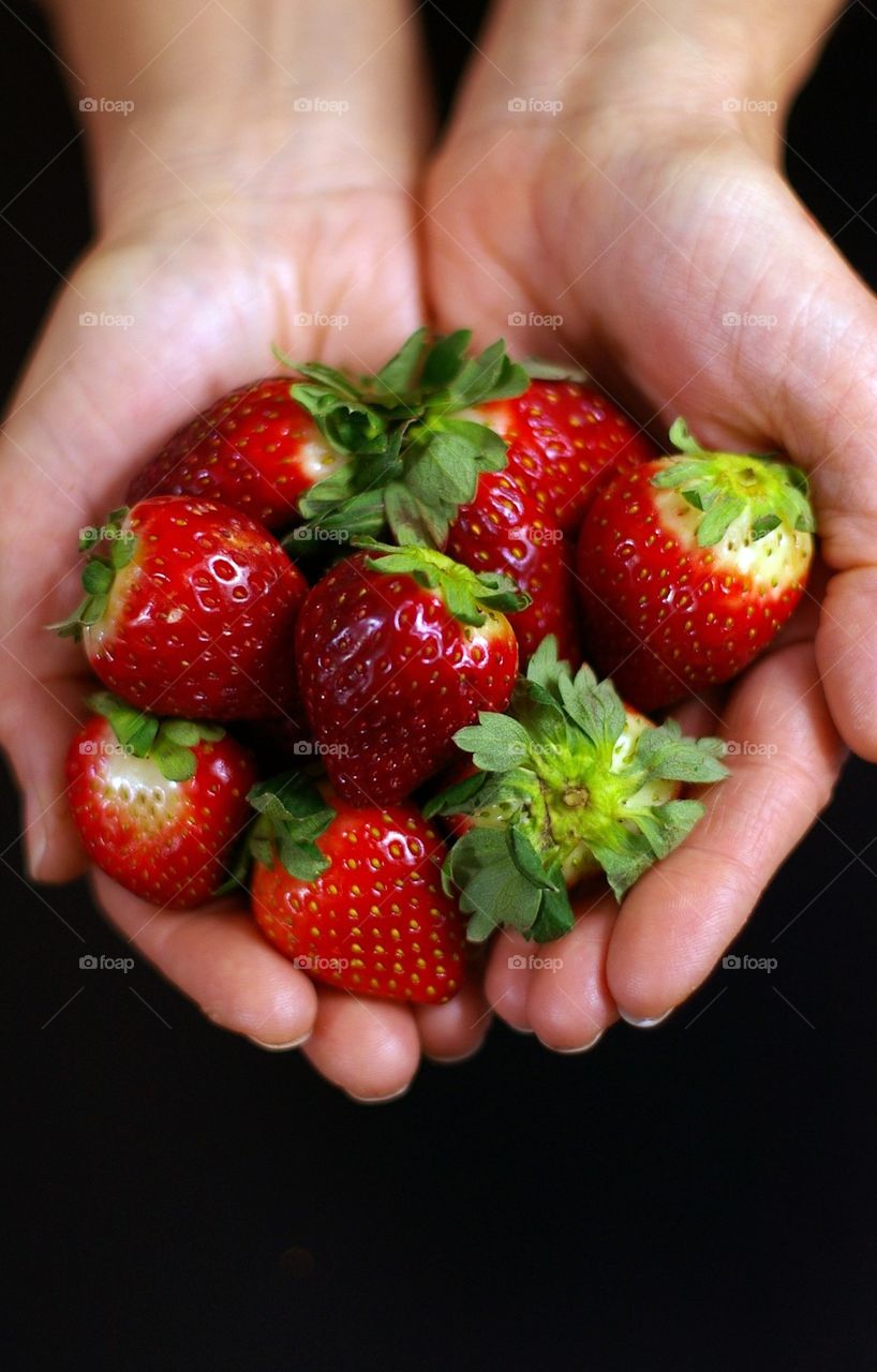 Hands full of strawberries 