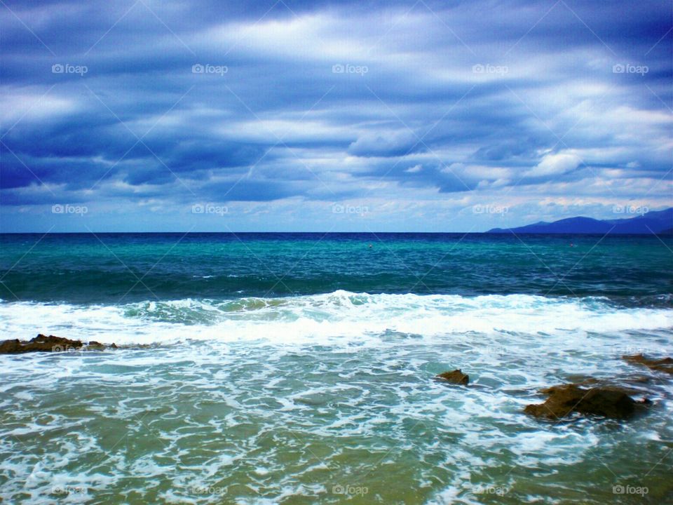 Stormy clouds and waves of the sea.