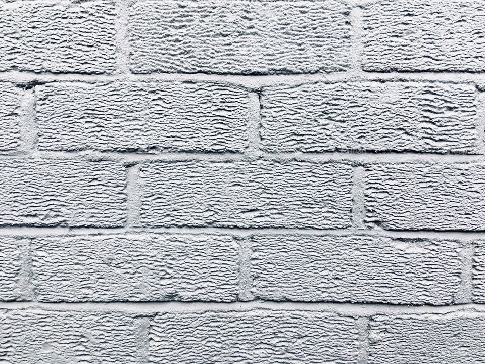 Grey brick wall close up texture background 
