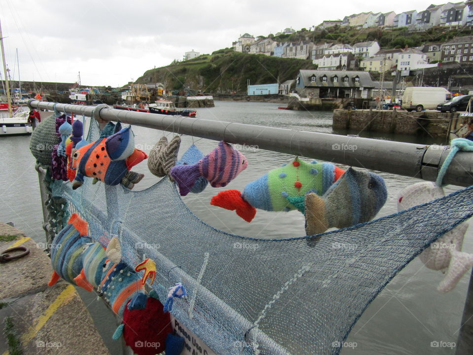 knitted fish display on railings in cornwall