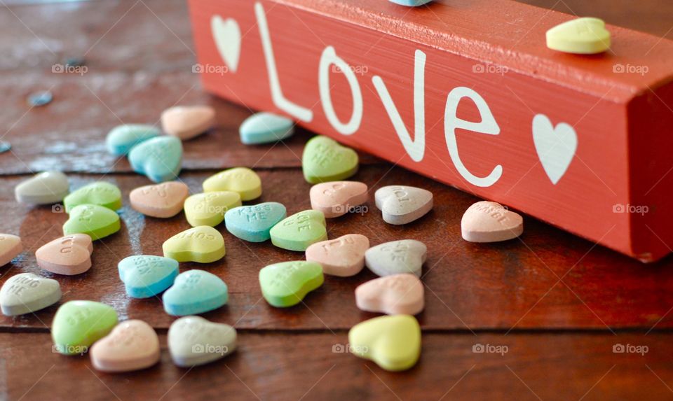 Heart shaped candy with a red Love sign