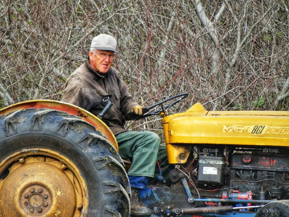 Farmer At Work Ploughing His Field
